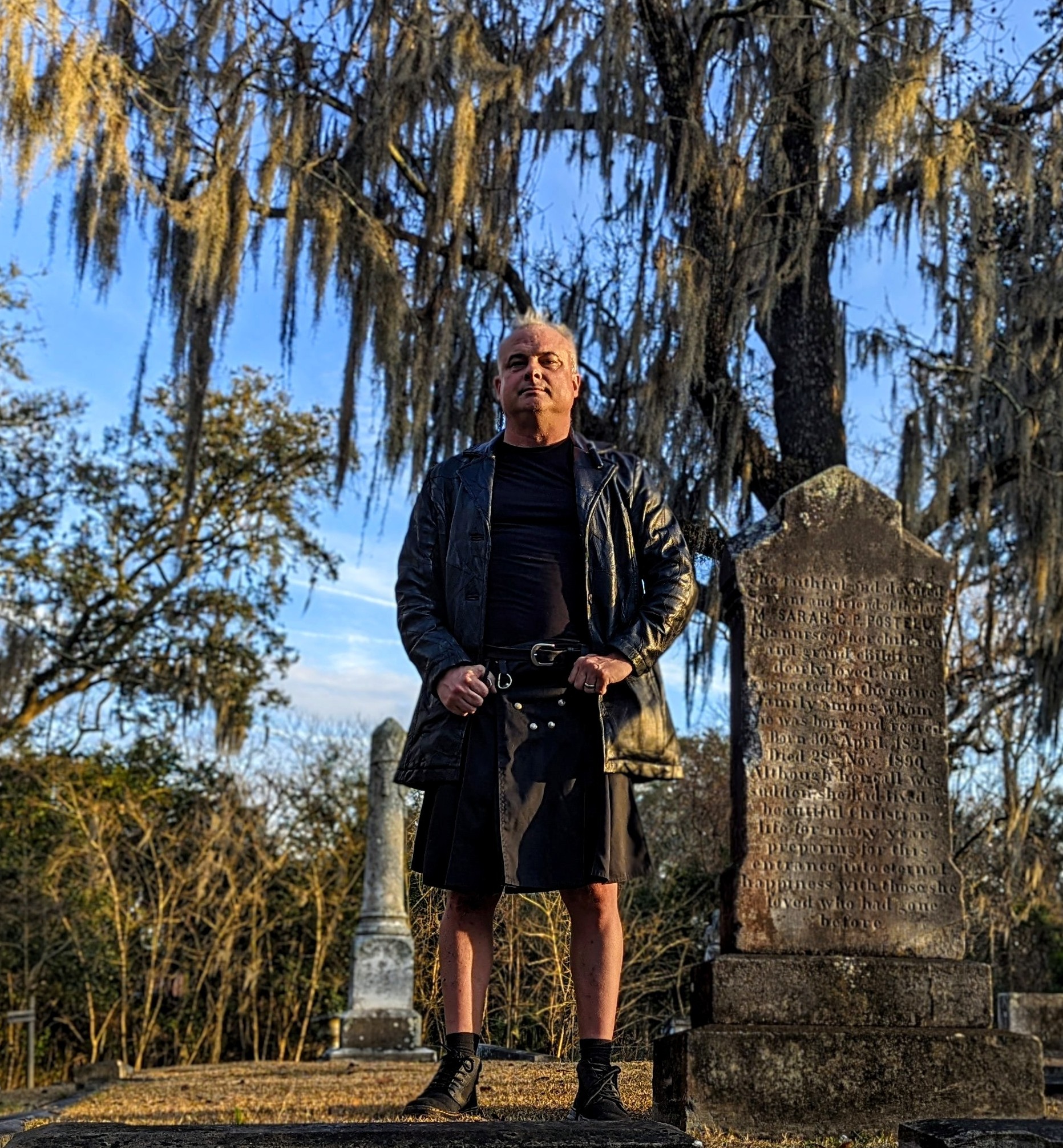 Patrick Burns — Savannah ghost tour guide and paranormal investigator, in kilt at a historic Savannah cemetery with Spanish moss and gravestones