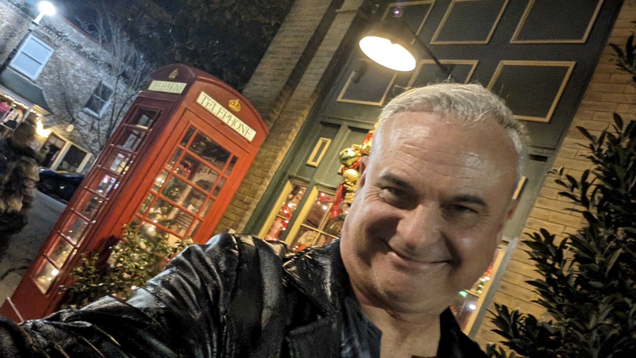 Patrick Burns Savannah guide selfie at night near a red British telephone box